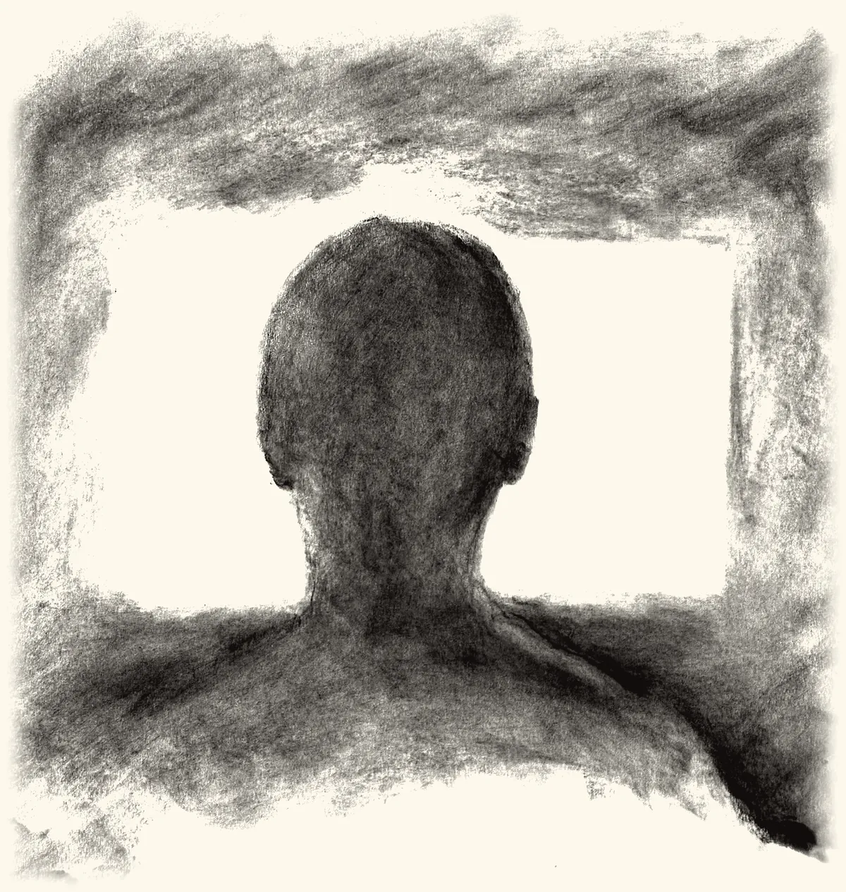 A man seen from behind against a glowing screen.