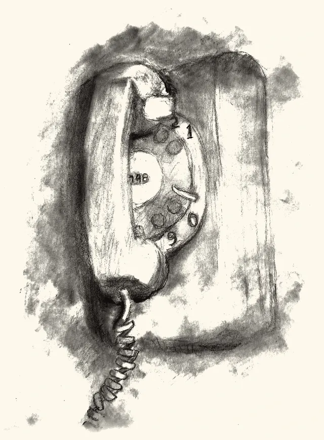 A rotary wall telephone with its coiled cord hanging loose.