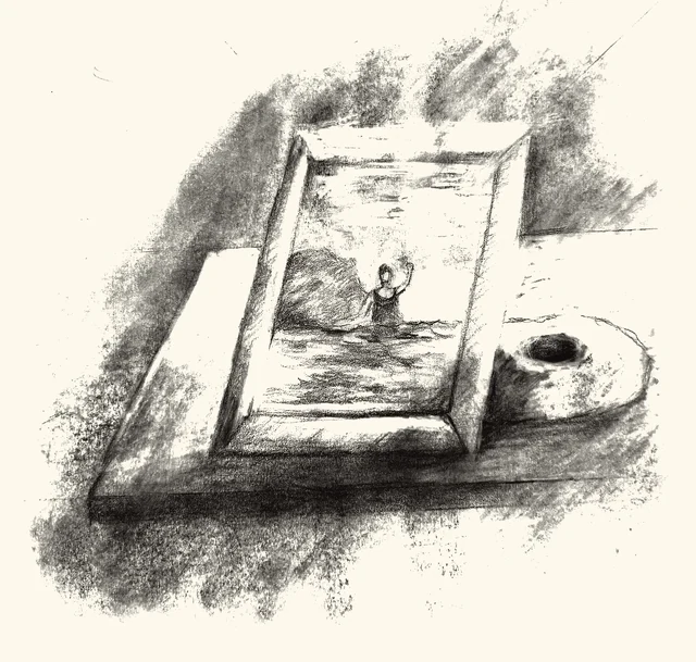A framed photograph of a swimmer waving, set on a table beside a donut.